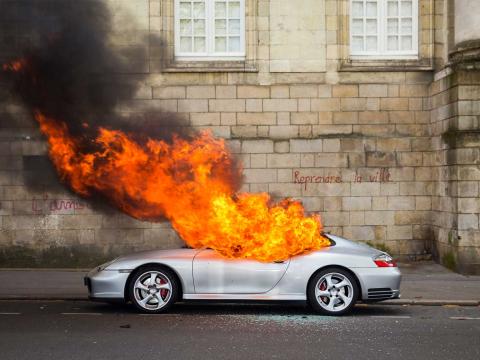 A Porsche burns in front of the Loire-Atlantique prefecture on the sidelines of a demonstration against the "Labor Law." Nantes, France - April 2016