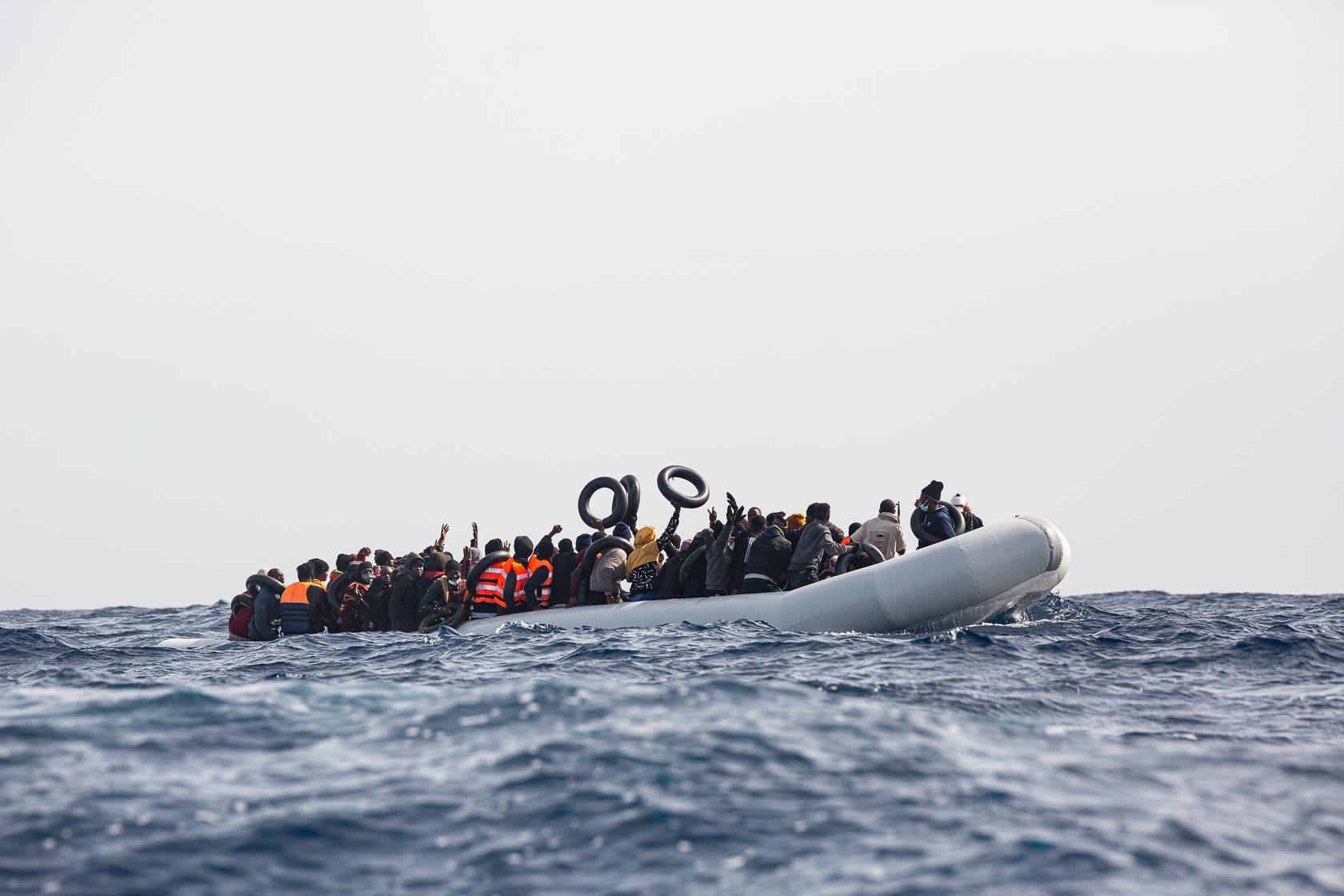 An overcrowded boat with more than 100 people on board is about to be rescued by the teams of the Ocean Viking, the search and rescue vessel of SOS Méditerranée. Central Mediterranean - April 2021